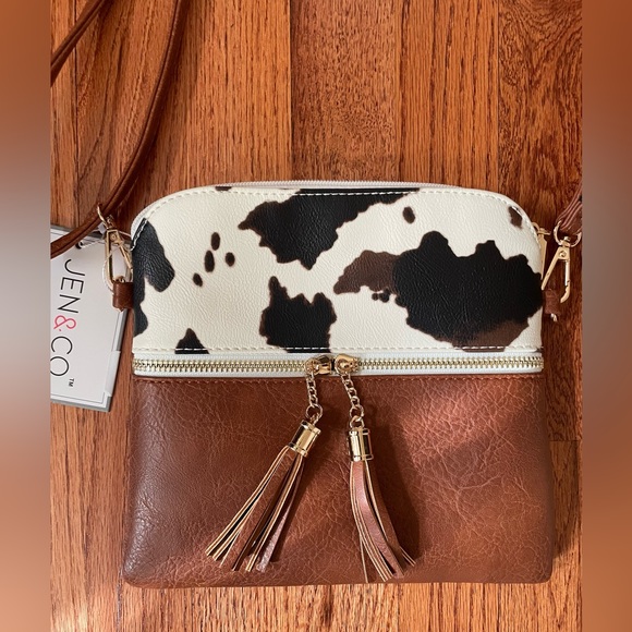Jen & Co Handbags - Tara Crossbody Cow Print with Tassel Zip. NWT!🐄